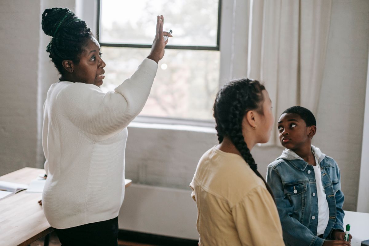Diverse adults raising hands during a rights education workshop